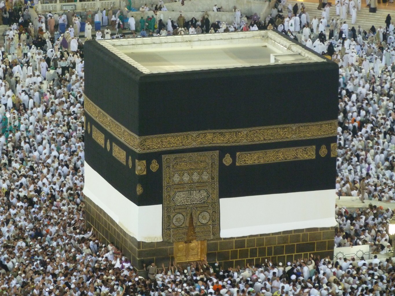 The Kaaba, in Arabic الكَعْبة, at the center of the mosque