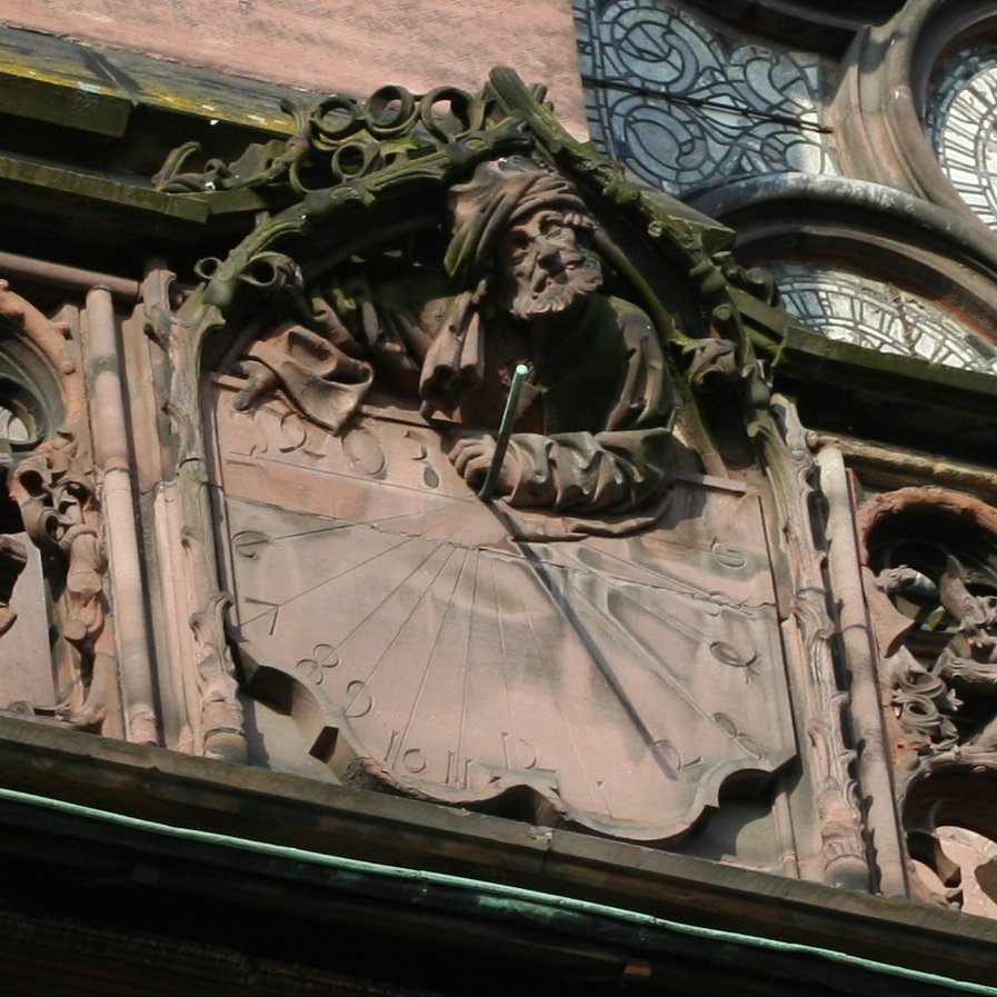 Polar-style sundial in Strasbourg Cathedral. The figure's left forearm, resting on top of the dial table, holds, or once held, the style in its hand.